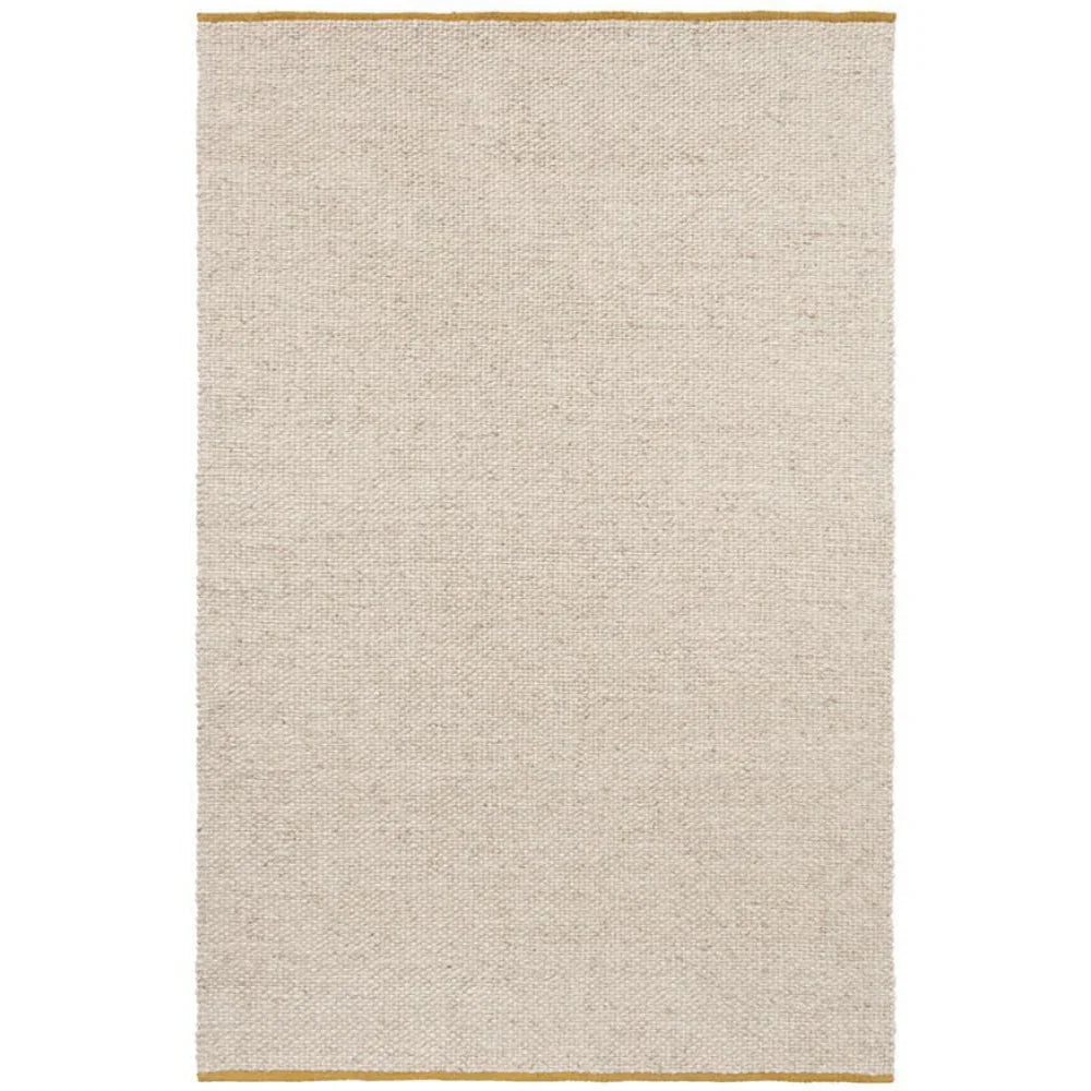 Brink & Campman Craft Matter Rug featuring plain design in warm white with golden border on edges, hand-tufted wool