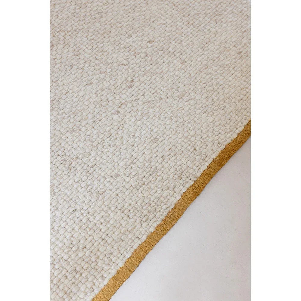 Brink & Campman Craft Matter Plain Warm White Rug featuring solid shag in warm white with mustard edge, hand-tufted wool
