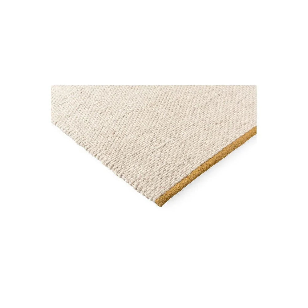 Brink & Campman Craft Matter Plain Warm White Designer Rug featuring plain textured weave with gold edge on warm white background, hand-tufted wool