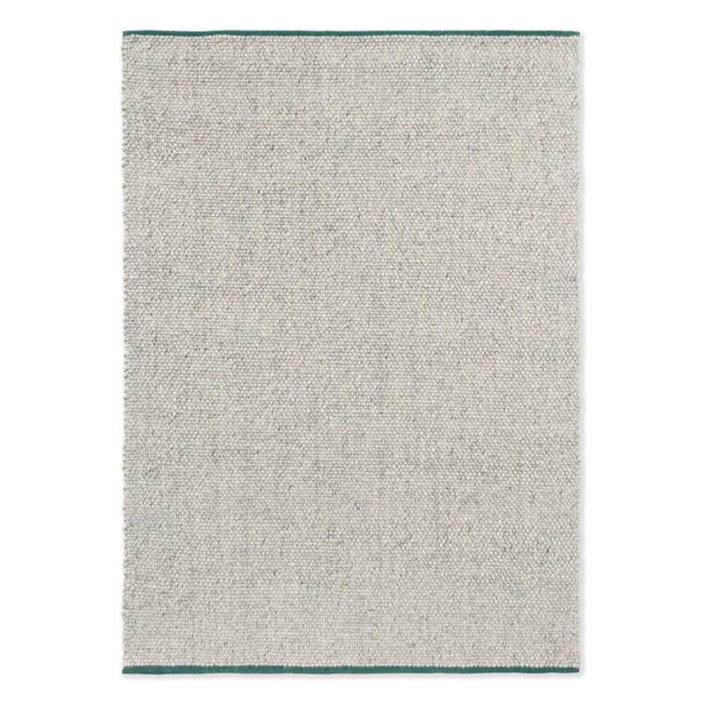 Brink & Campman Craft Matter Rug featuring plain ash grey with teal edge trim, hand-tufted wool
