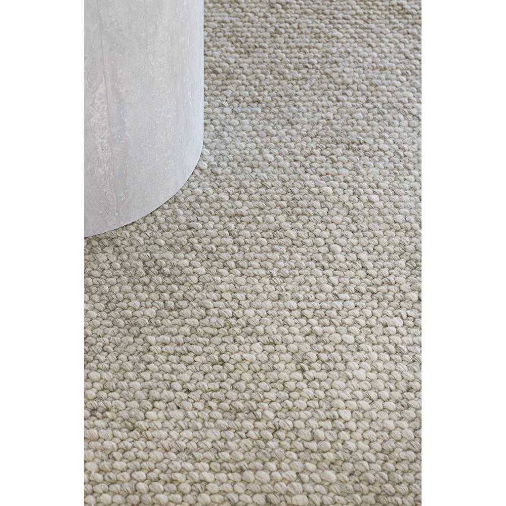 Brink & Campman Craft Matter Plain Ash Grey Designer Rug featuring textured boucle in ash grey on pale beige background, machine-made wool-blend