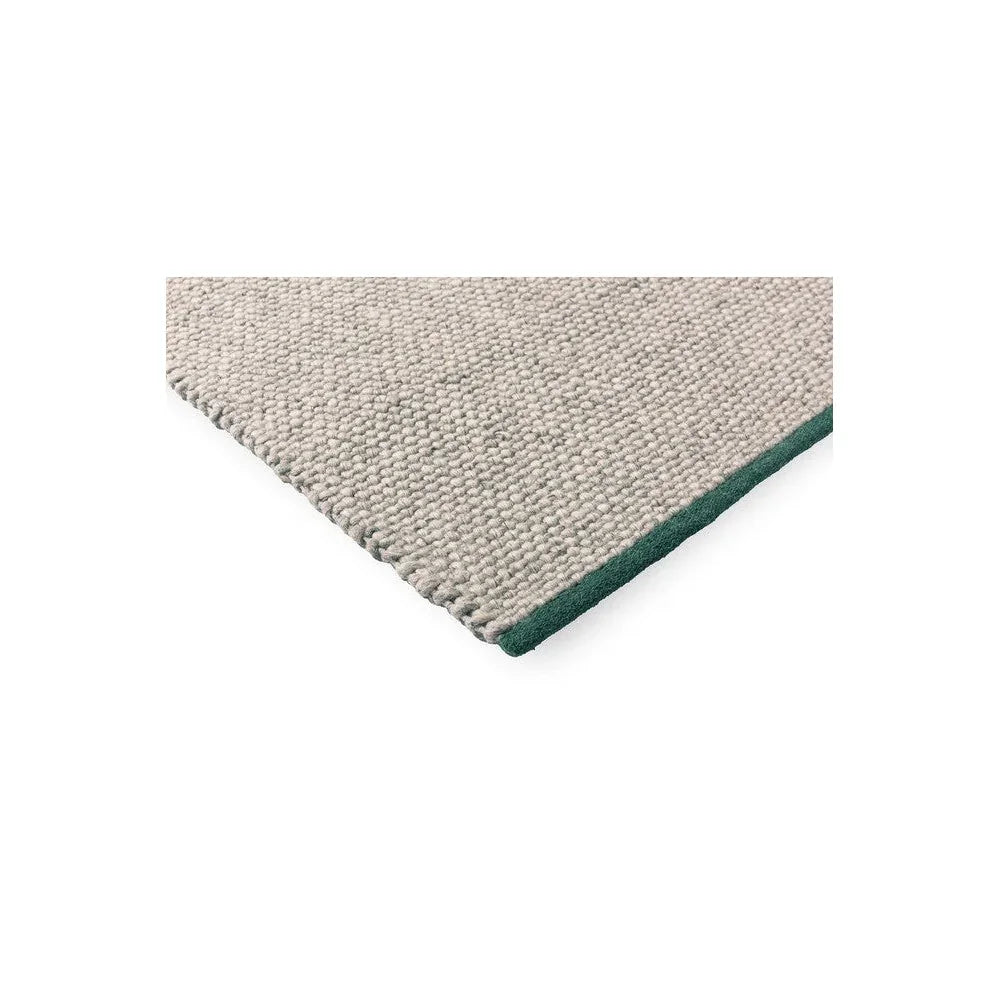 Brink & Campman Craft Matter Rug featuring ash grey loop pile with green edge, modern plain design, hand-tufted wool