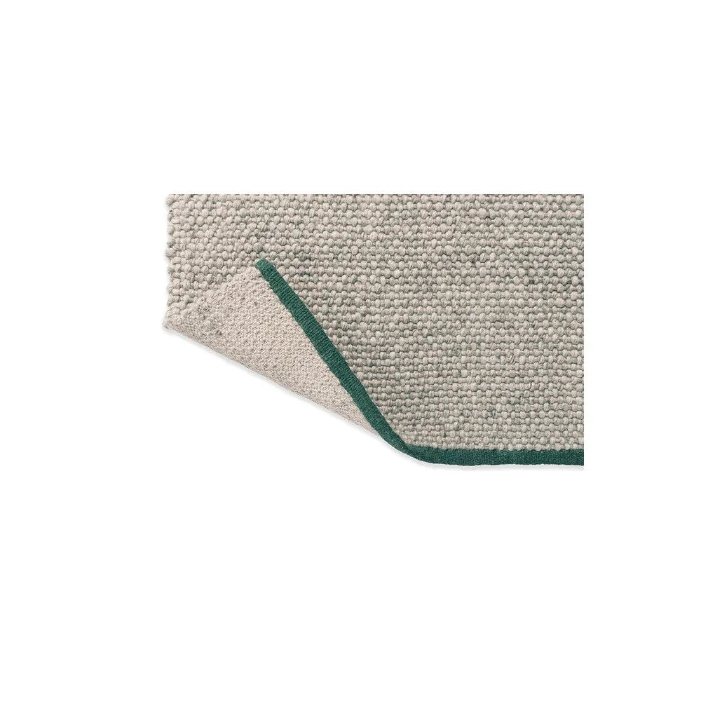 Brink & Campman Craft Matter Plain Ash Grey Designer Rug featuring plain ash grey surface with green border on white background, hand-tufted wool