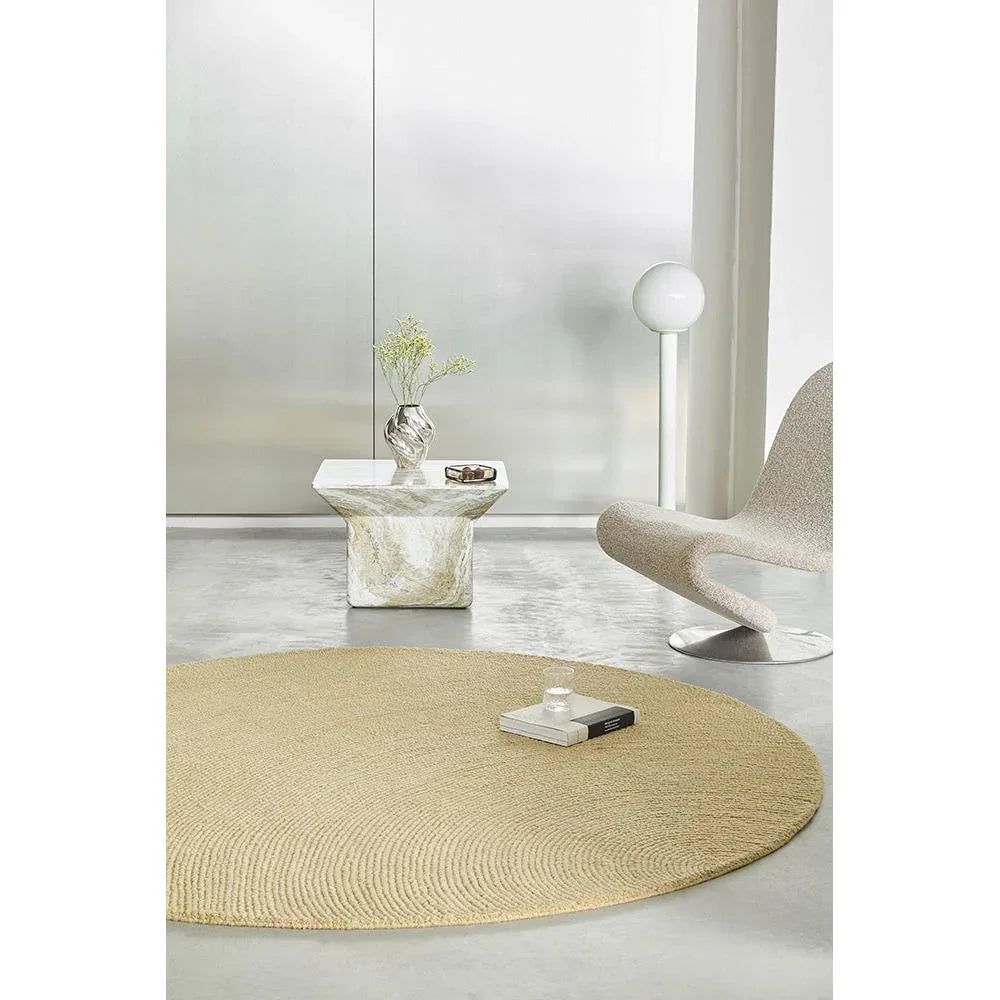 B&C Decor Echo Sand Round Rug featuring woven texture in sand, beige and cream on light grey floor, hand-woven jute