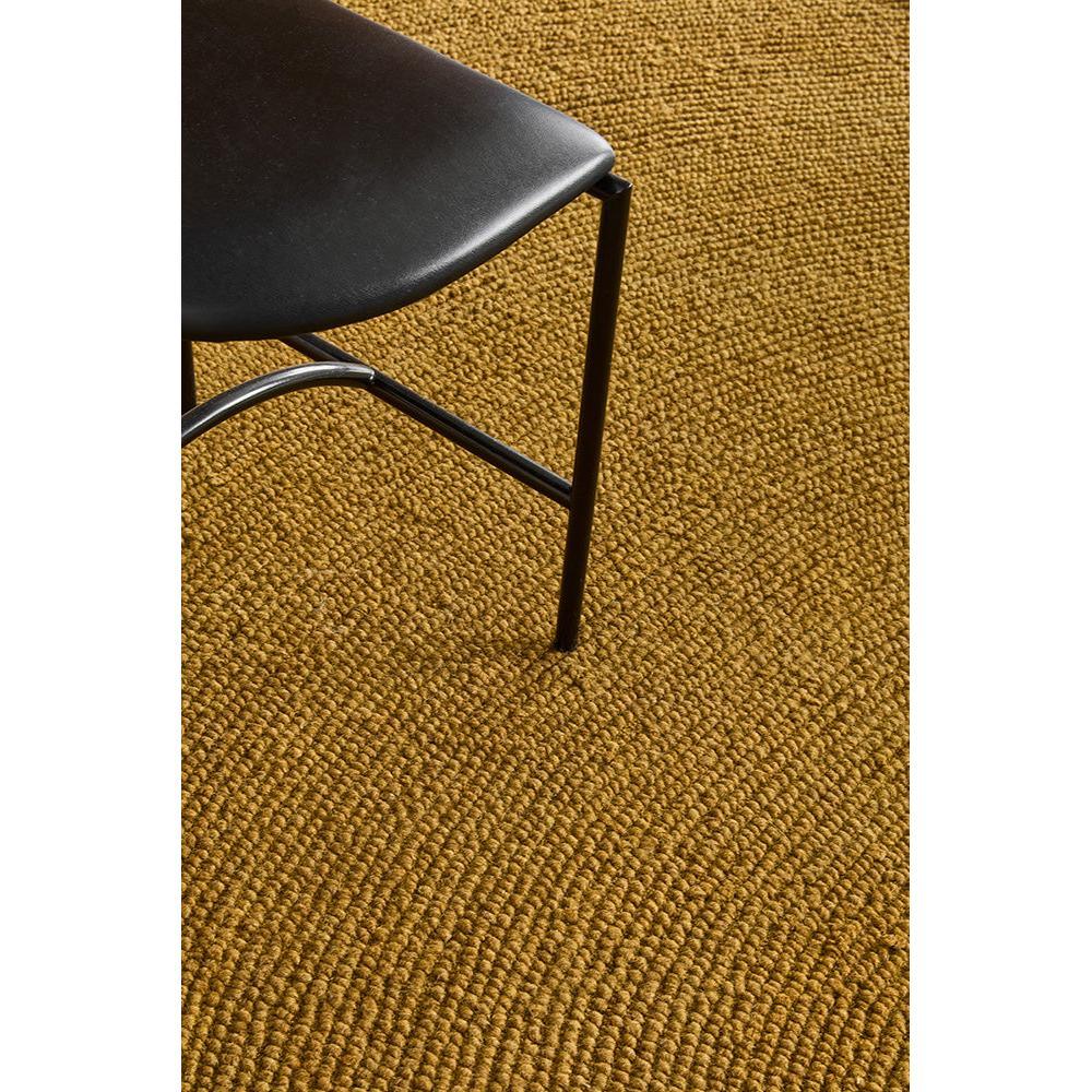 B&C Decor Echo Ochre Round Rug featuring textured solid pattern in ochre and golden yellow on warm brown floor, machine-made wool