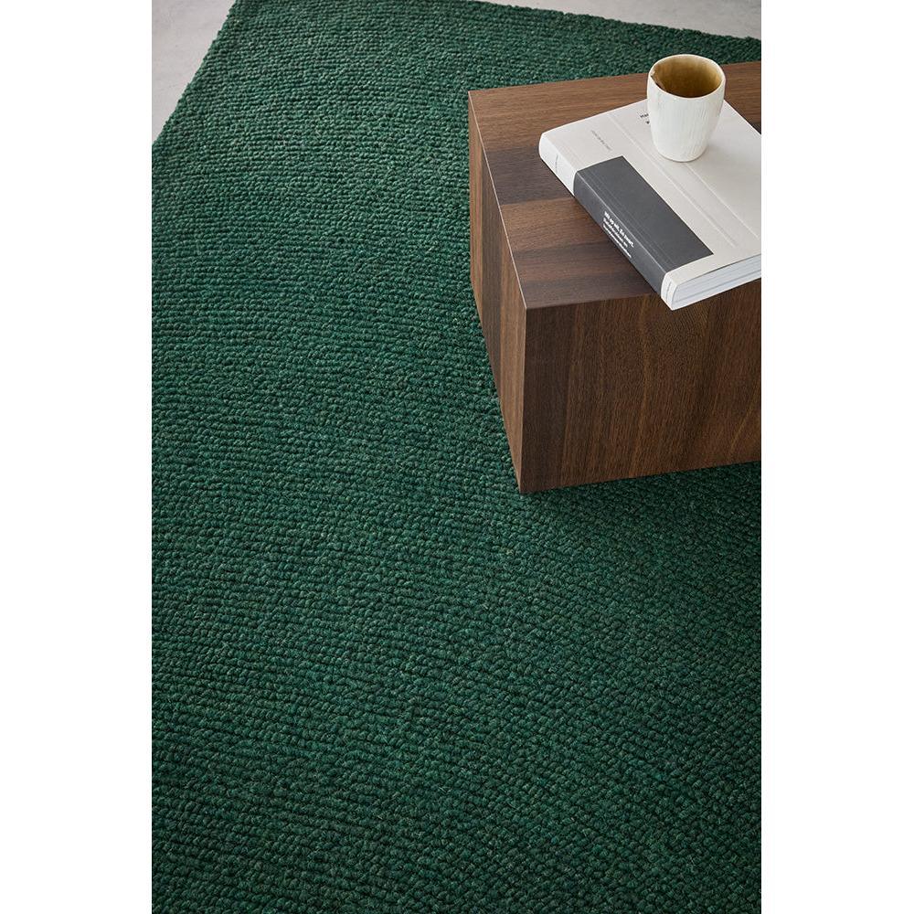 B&C Decor Echo Forest Designer Rug featuring solid textured boucle in forest green on dark walnut floor, hand-tufted wool