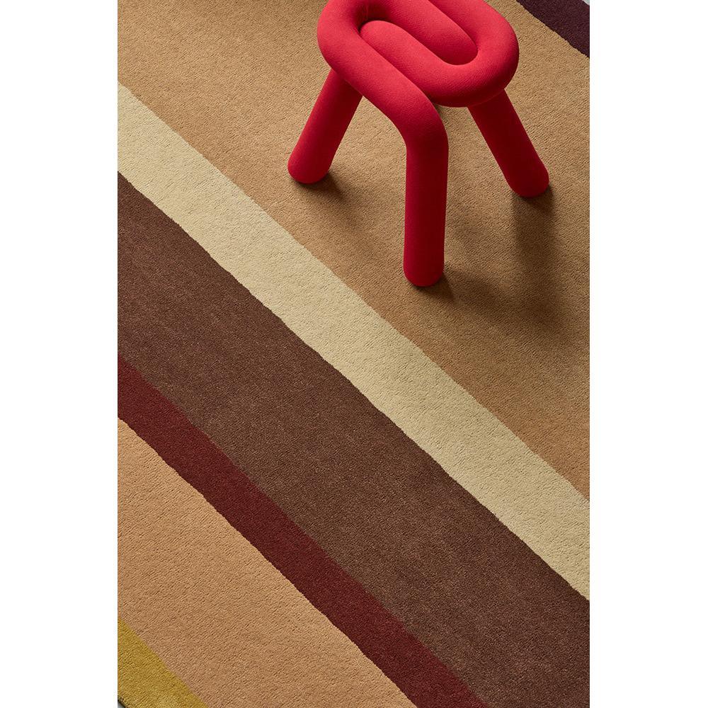 B&C Decor Linear Ruby Rug featuring diagonal stripe pattern in ochre, beige, tan, rust on warm beige background, hand-tufted wool