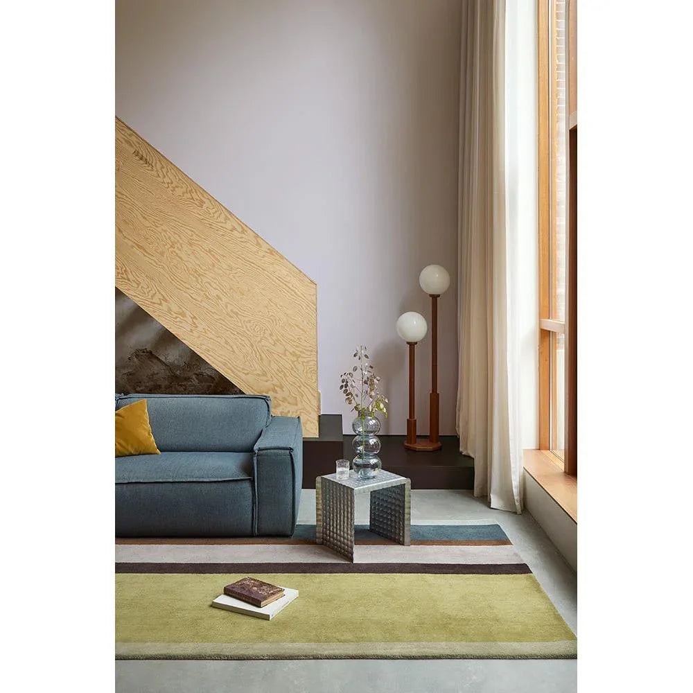 B&C Decor Linear Retro Rug featuring striped geometric pattern in olive green, mustard, beige, brown and blue on pale cream floor, wool