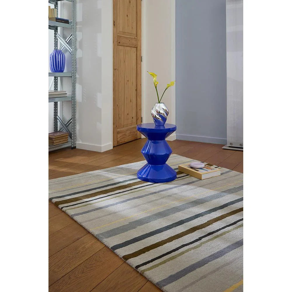 B&C Decor Shift Steel Metal Designer Rug featuring striped abstract pattern in ivory, grey, taupe, navy and mustard on warm oak floor, machine-made wool