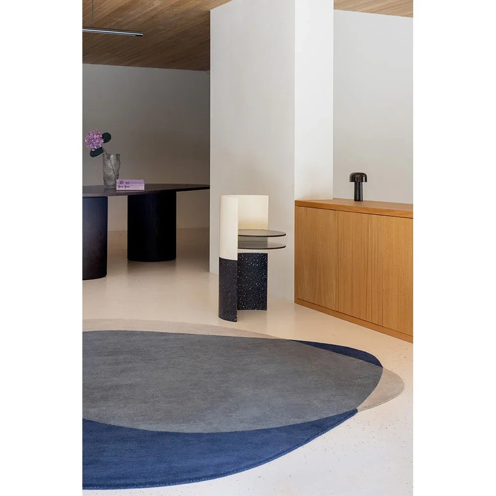 Brink & Campman Element Arp Blue rug featuring circular geometric pattern in navy, grey and light blue on pale beige background, construction/material unknown