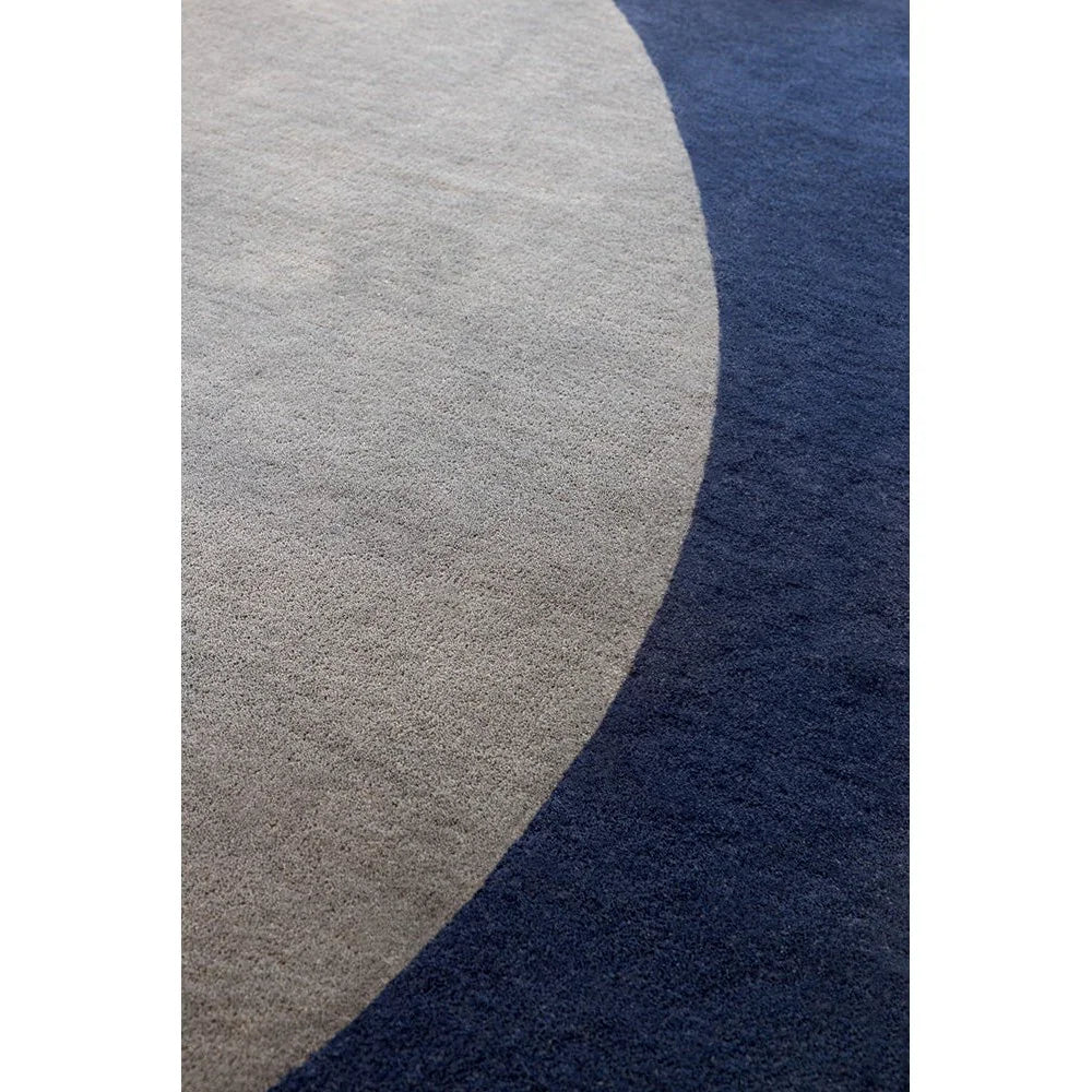 Brink & Campman Element Arp Blue Designer Rug featuring abstract circular pattern in beige and taupe on navy background, hand-tufted wool