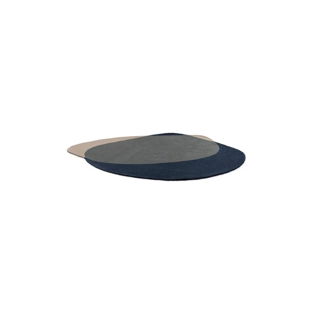 Brink & Campman Element Arp Blue Rug featuring abstract circular pattern in navy, steel blue and beige on ivory, hand-tufted wool