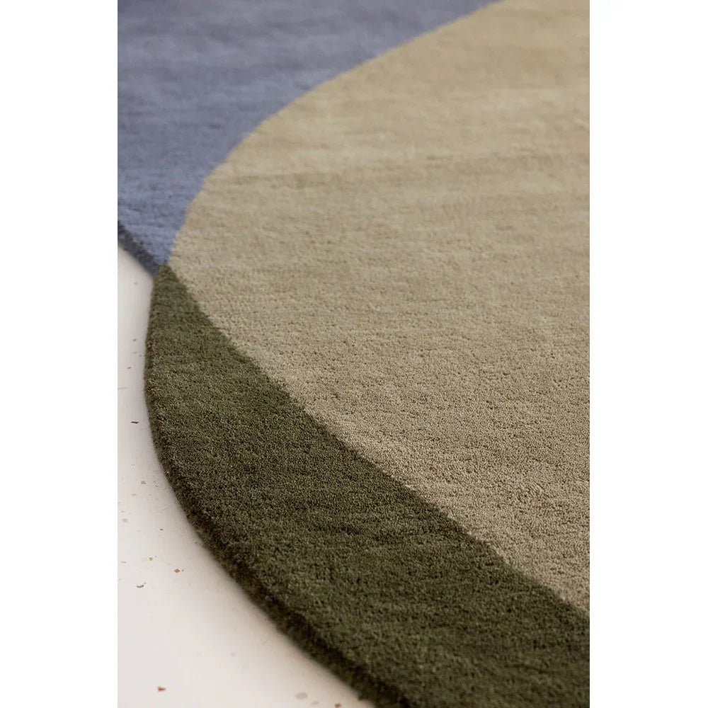 Brink & Campman Element Chad Grey Green Rug featuring curved blocks in slate blue, beige and olive on cream background, hand-tufted wool