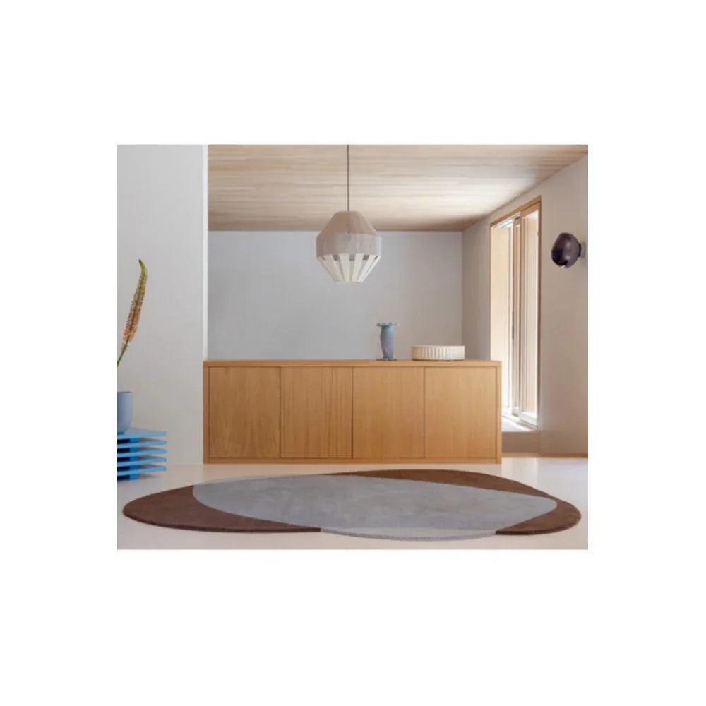 Brink & Campman Element Chad Brown Blue Designer Rug featuring circular pattern in chocolate brown, taupe and light grey on cream floor, hand-tufted wool