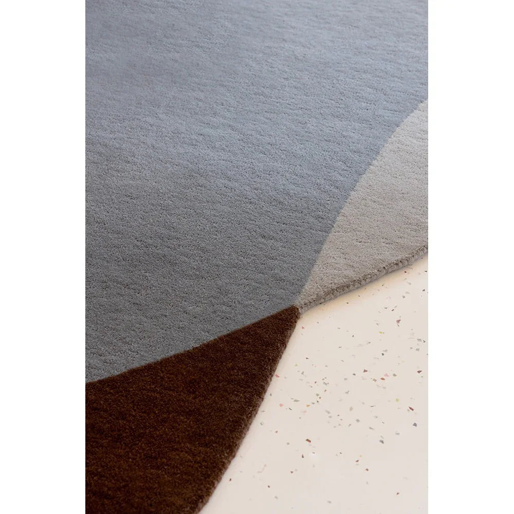 Brink & Campman Element Chad Brown Blue Rug featuring abstract geometric blocks in navy, steel blue, taupe and chocolate brown on cream background, hand-tufted wool
