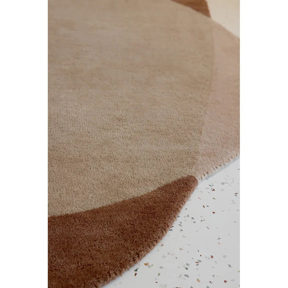 Brink & Campman Element Moore Caramel Rug featuring circular color-block in caramel, tan, beige and brown on cream backdrop, hand-tufted wool