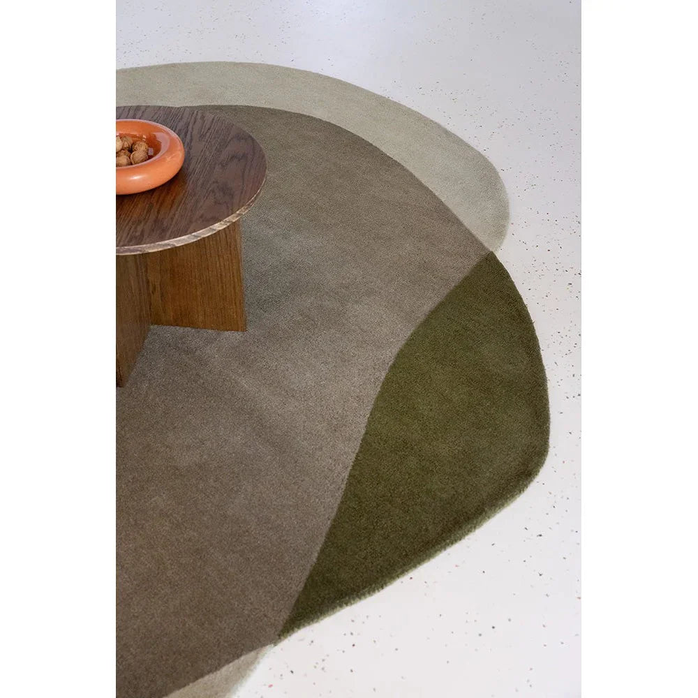 Brink & Campman Element Moore Moss Rug featuring abstract circular pattern in moss green, taupe and beige on light speckled background, hand-tufted wool