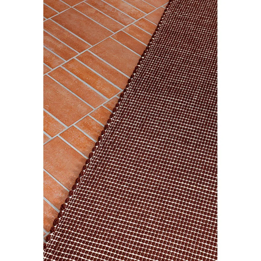 Brink & Campman Frame Brick Designer Rug featuring grid pattern in brick red and cream on terracotta background, hand-tufted wool