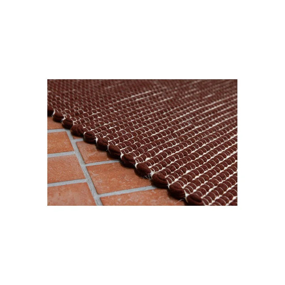 Brink & Campman Frame Brick Designer Rug featuring braided stripe in chocolate brown and cream on terracotta, hand-tufted wool
