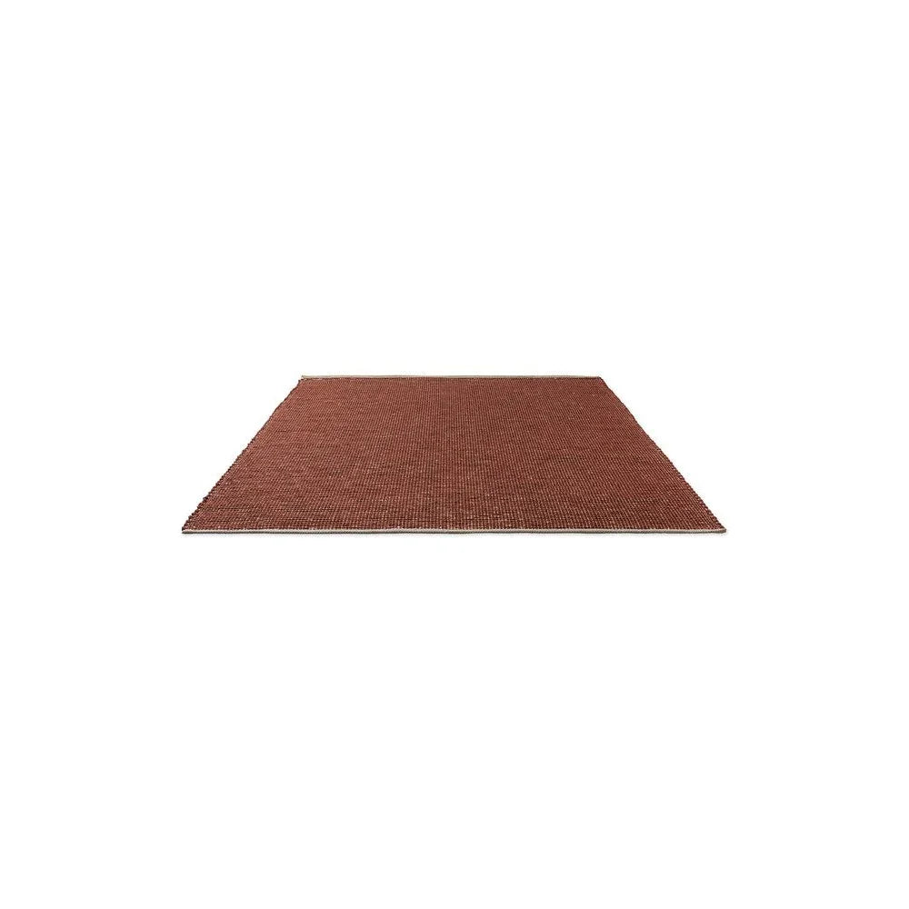 Brink & Campman Frame Brick Designer Rug featuring a subtle geometric pattern in brick red, rust, and brown on white background
