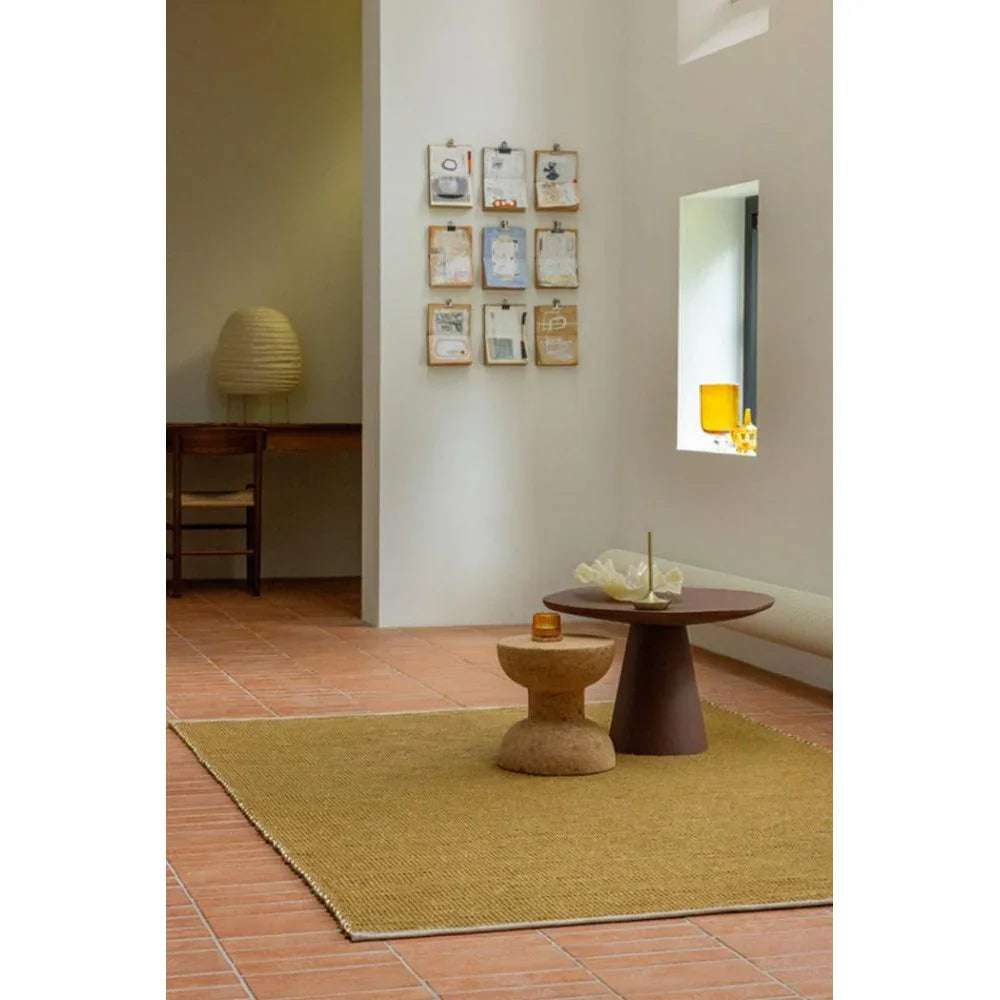 Brink & Campman Frame Mustard Rug featuring solid frame-inspired design in mustard on terracotta floor, hand-tufted wool