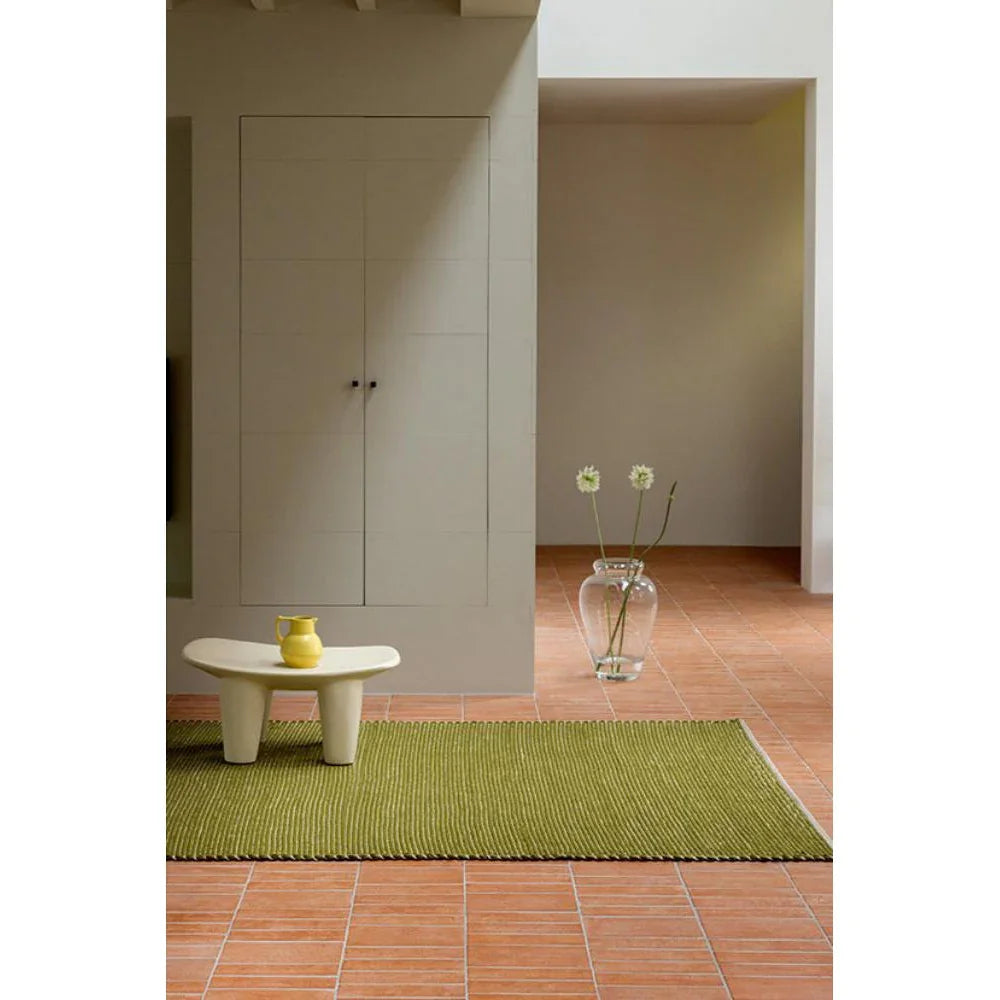 Brink & Campman Frame Leaf Designer Rug featuring botanical motif in olive green on terracotta tile, hand-tufted wool