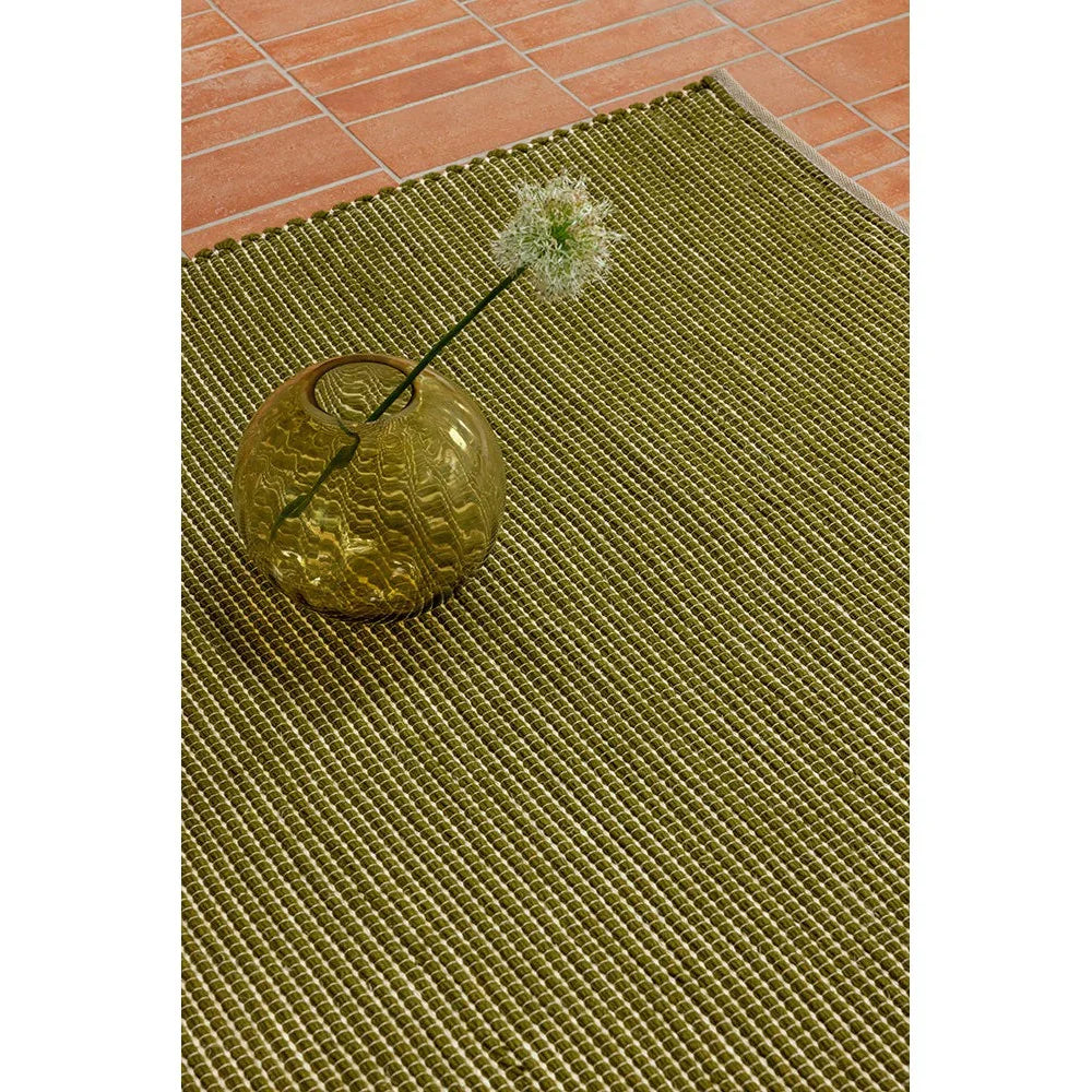 Brink & Campman Frame Leaf Designer Rug featuring leaf-textured pattern in olive green and cream on terracotta, hand-tufted wool