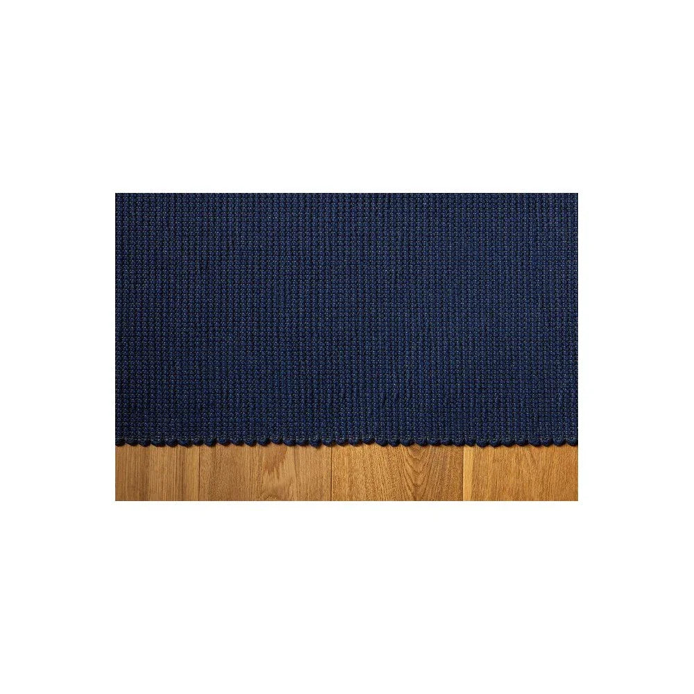 Brink & Campman Grid Ink Designer Rug featuring ribbed navy blue texture on wood floor, woven construction