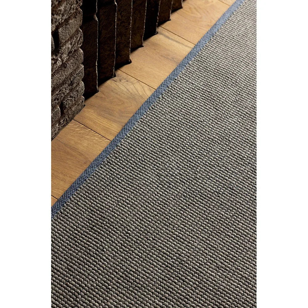 Brink & Campman Grid Stone Rug featuring textured grid weave in grey with navy border on natural wood floor, machine-woven wool