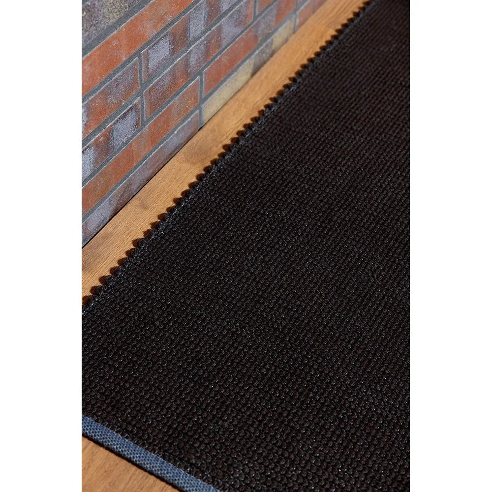 Brink & Campman Grid Cacao rug featuring grid pattern in dark cacao brown with a blue edge on warm wood, hand-woven wool