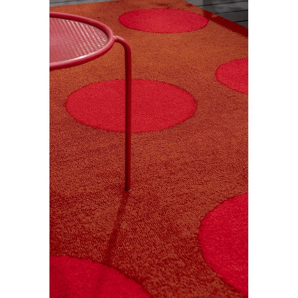 Brink & Campman Habitat Dots rug featuring bold red dot pattern on burnt orange background, indoor/outdoor use, synthetic fibers