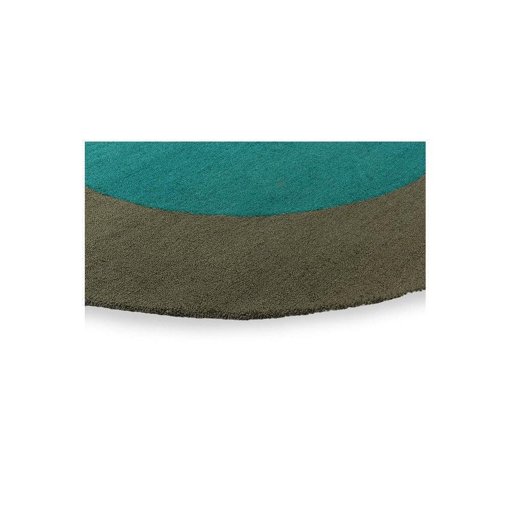 Brink & Campman Habitat Festival Round Aqua Rug featuring aqua-teal and olive-brown curved blocks on white, power-loomed polypropylene