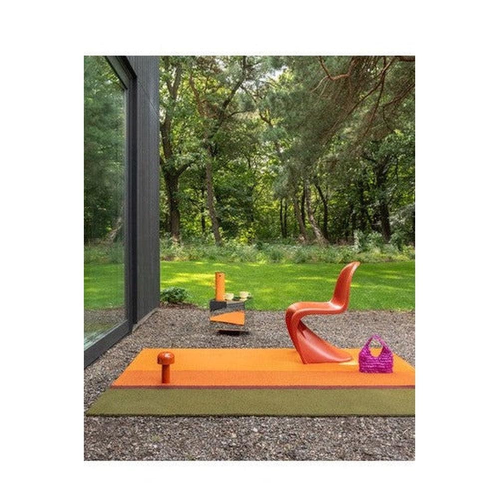 Brink & Campman Habitat Festival Stripe Orange Outdoor Designer Rug featuring stripe pattern in orange, coral, olive on green lawn background, power-loomed polypropylene