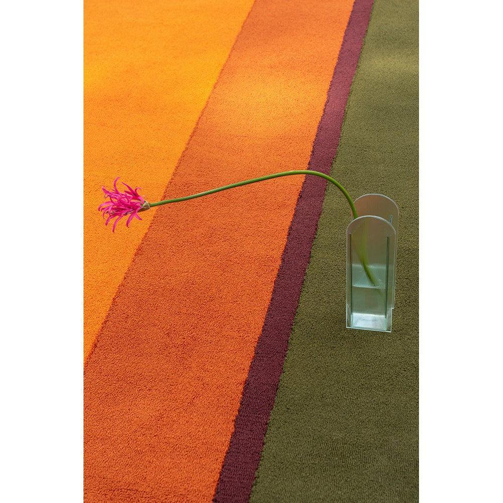 Brink & Campman Habitat Festival Stripe Orange Outdoor Designer Rug featuring bold stripe pattern in orange, tangerine, burgundy, olive on muted olive-green background, machine-woven polypropylene