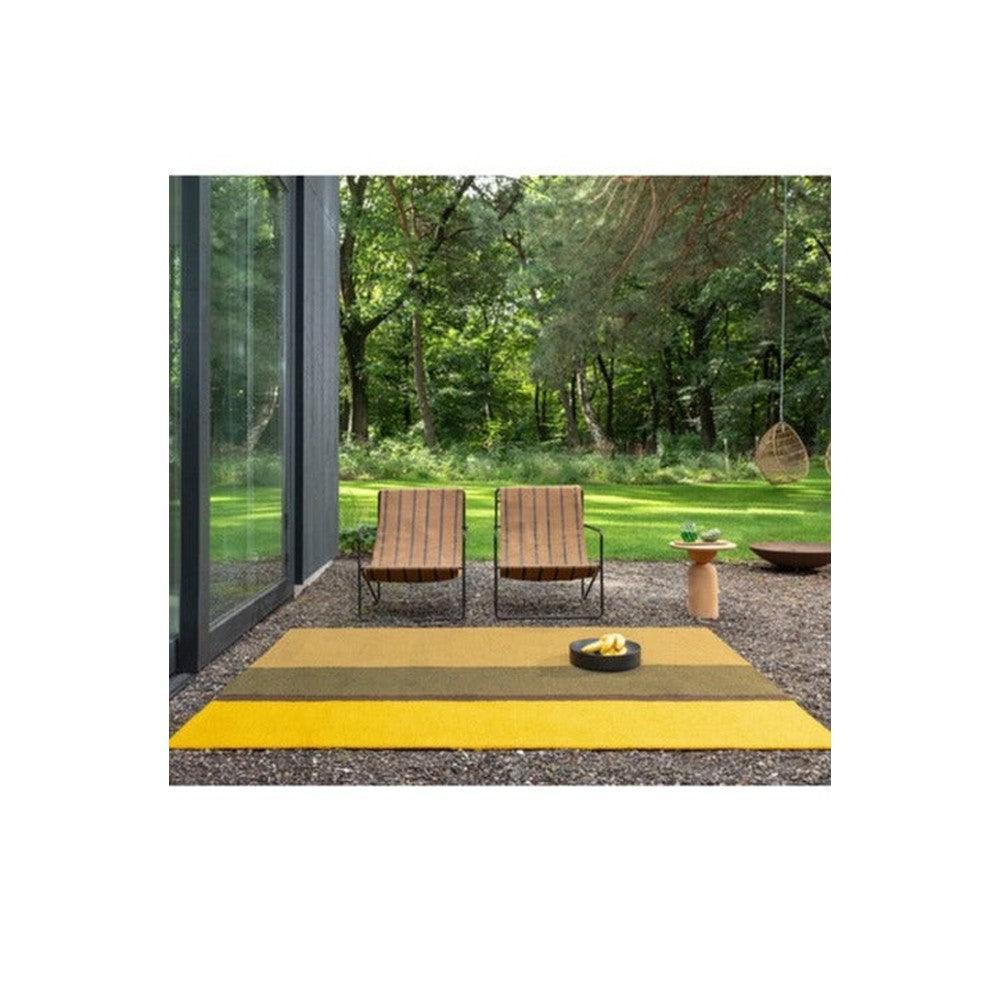 Brink & Campman Habitat Festival Stripe Yellow outdoor rug featuring yellow, mustard & olive stripes on grey background, power-loomed polypropylene