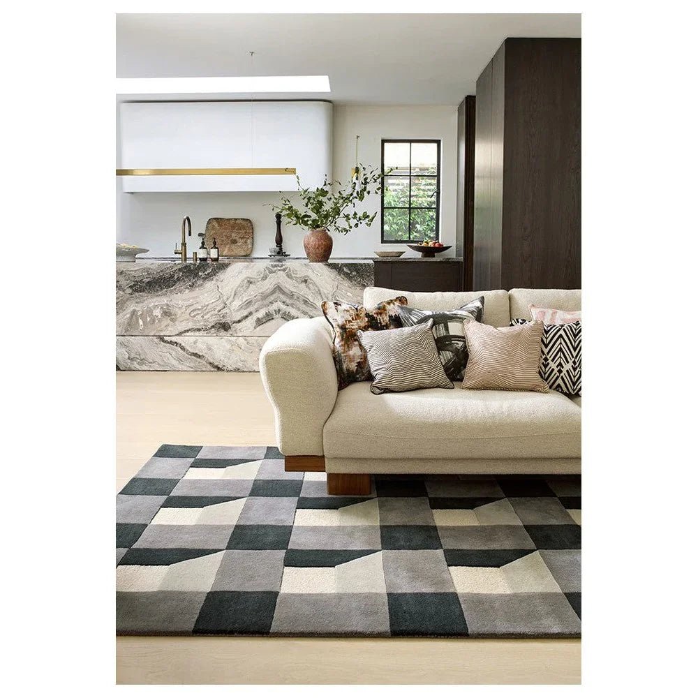 Harlequin Blocks Slate Designer Rug featuring geometric checkerboard pattern in charcoal, slate gray, light gray and ivory on beige background, hand-tufted wool
