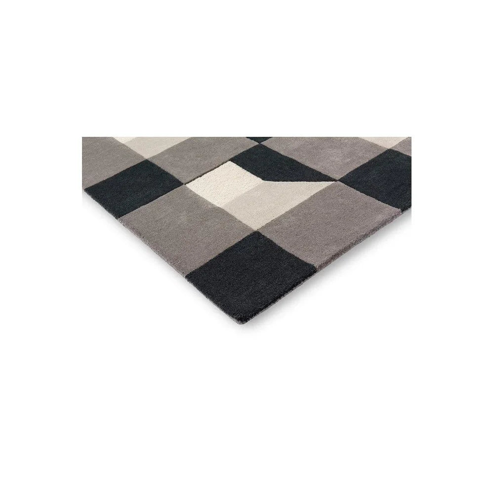 Harlequin Blocks Slate Designer Rug featuring checker-like blocks in slate, charcoal, cream on white, hand-tufted wool