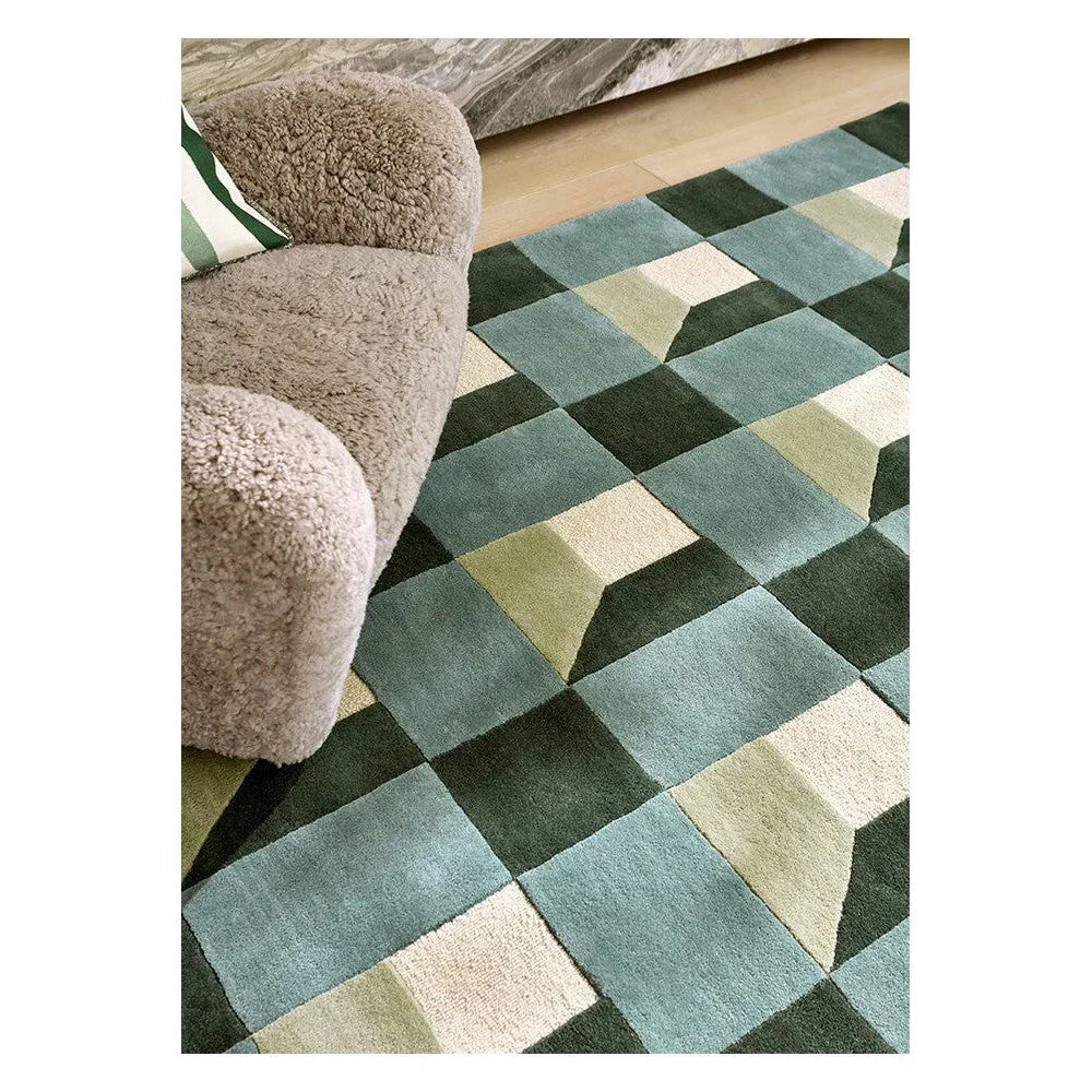 Harlequin Blocks Fern Designer Rug featuring geometric patchwork in teal, sage, moss and cream on light beige background, hand-tufted wool
