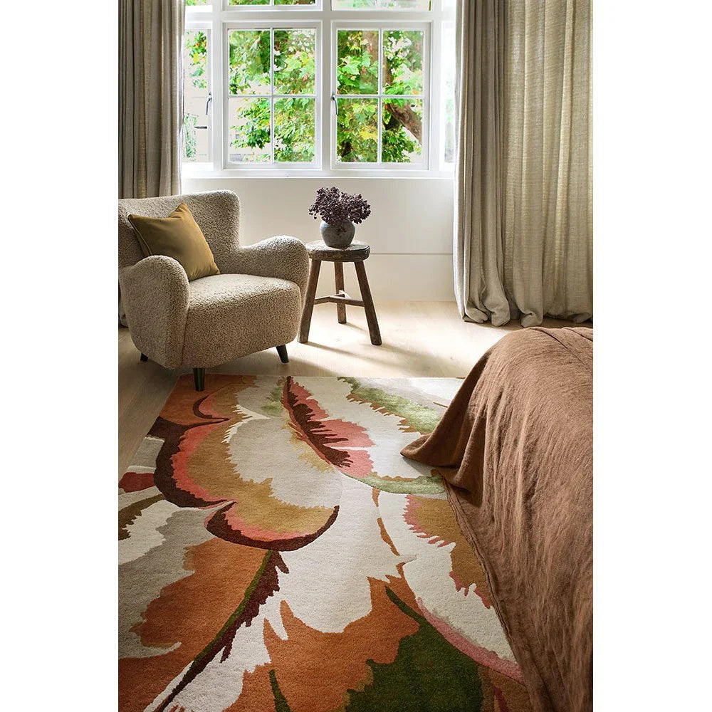 Harlequin Calathea Amber/Brazilian Rosewood Designer Rug featuring botanical leaf pattern in amber, rust, pink, sage on cream background, machine-woven