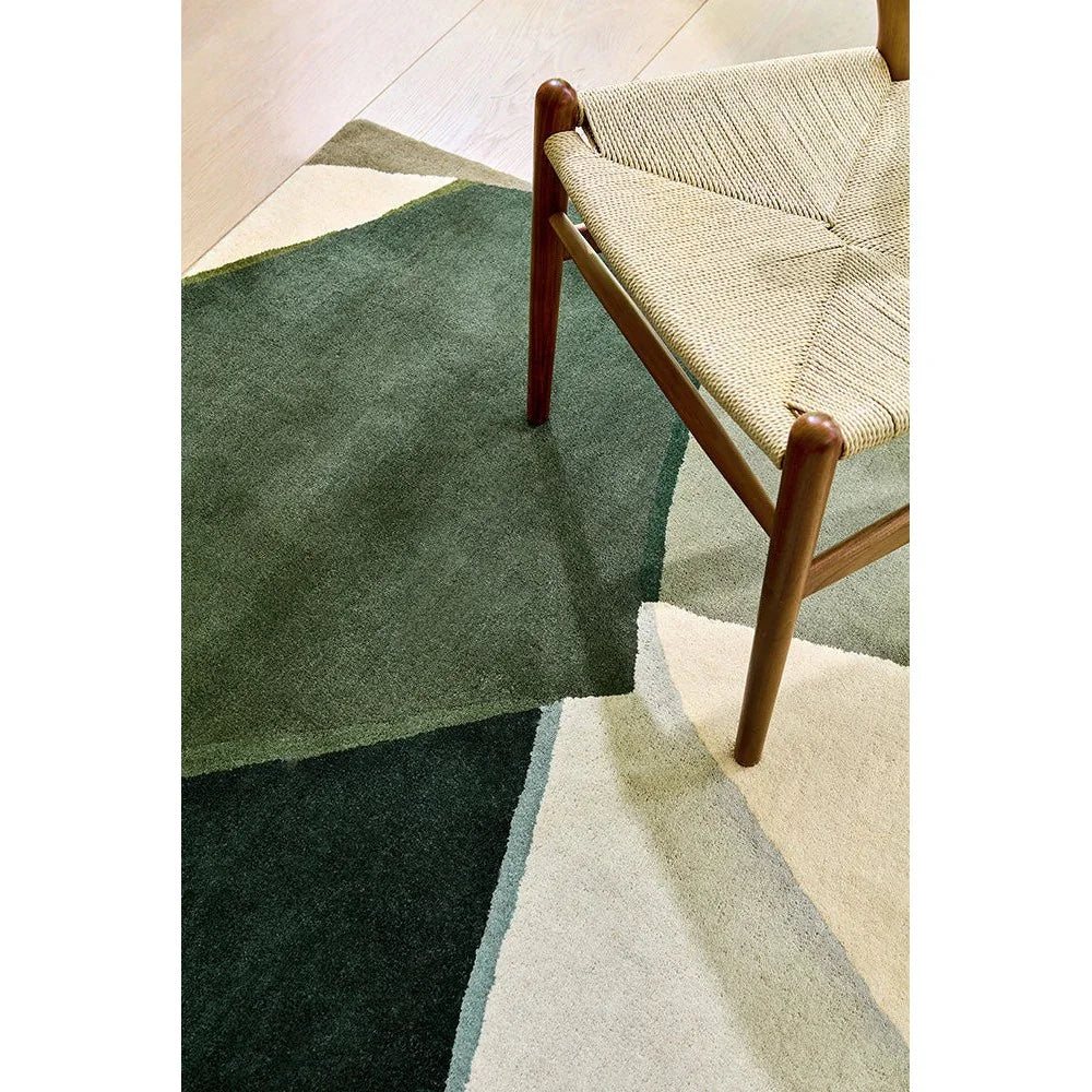 Harlequin Sumi Reflect Fern/pistachio Designer Rug featuring geometric color-block pattern in forest green, sage and cream on pale floor, hand-tufted wool