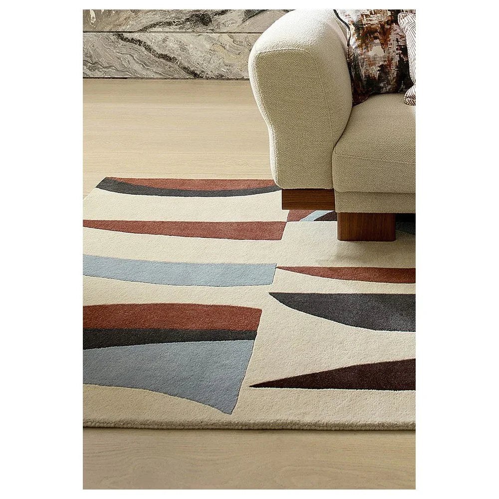 Harlequin Torillo Cornflower / Walnut Designer Rug featuring abstract curved pattern in cornflower blue, walnut brown, rust, charcoal on cream background, hand-tufted wool