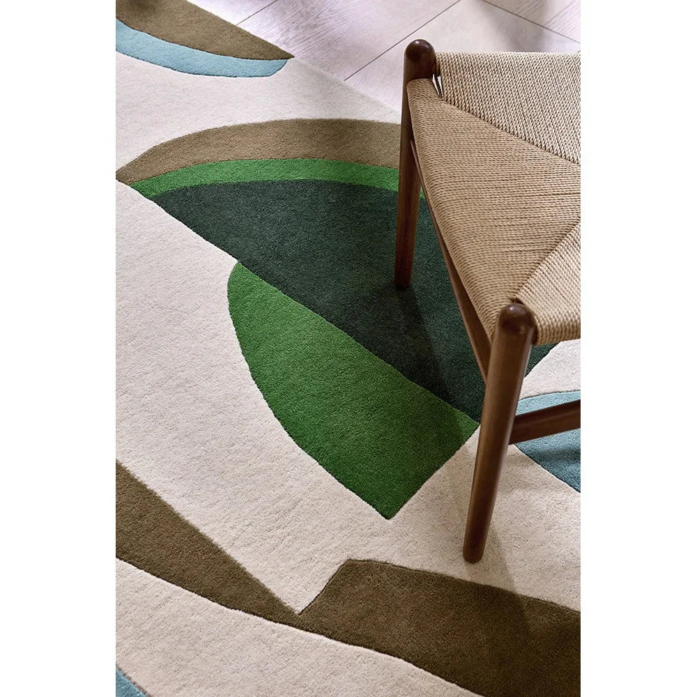 Harlequin Torillo Emerald / Azul Designer Rug featuring abstract geometric pattern in emerald green, dark green, beige, tan and light blue on cream background, hand-tufted wool