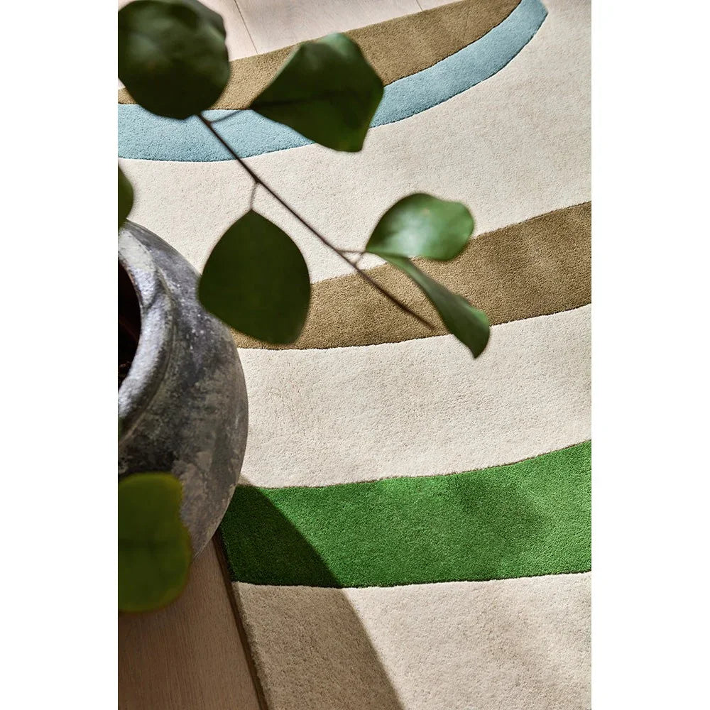 Harlequin Torillo Emerald/Azul Rug featuring abstract curved stripes in emerald, blue and tan on cream, hand-tufted wool
