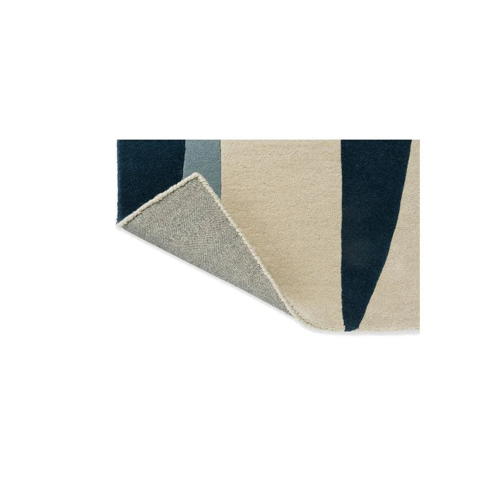 Harlequin Torillo Sky/Cornflower rug featuring geometric stripe pattern in navy, cornflower blue, beige and cream on ivory background, hand-tufted wool