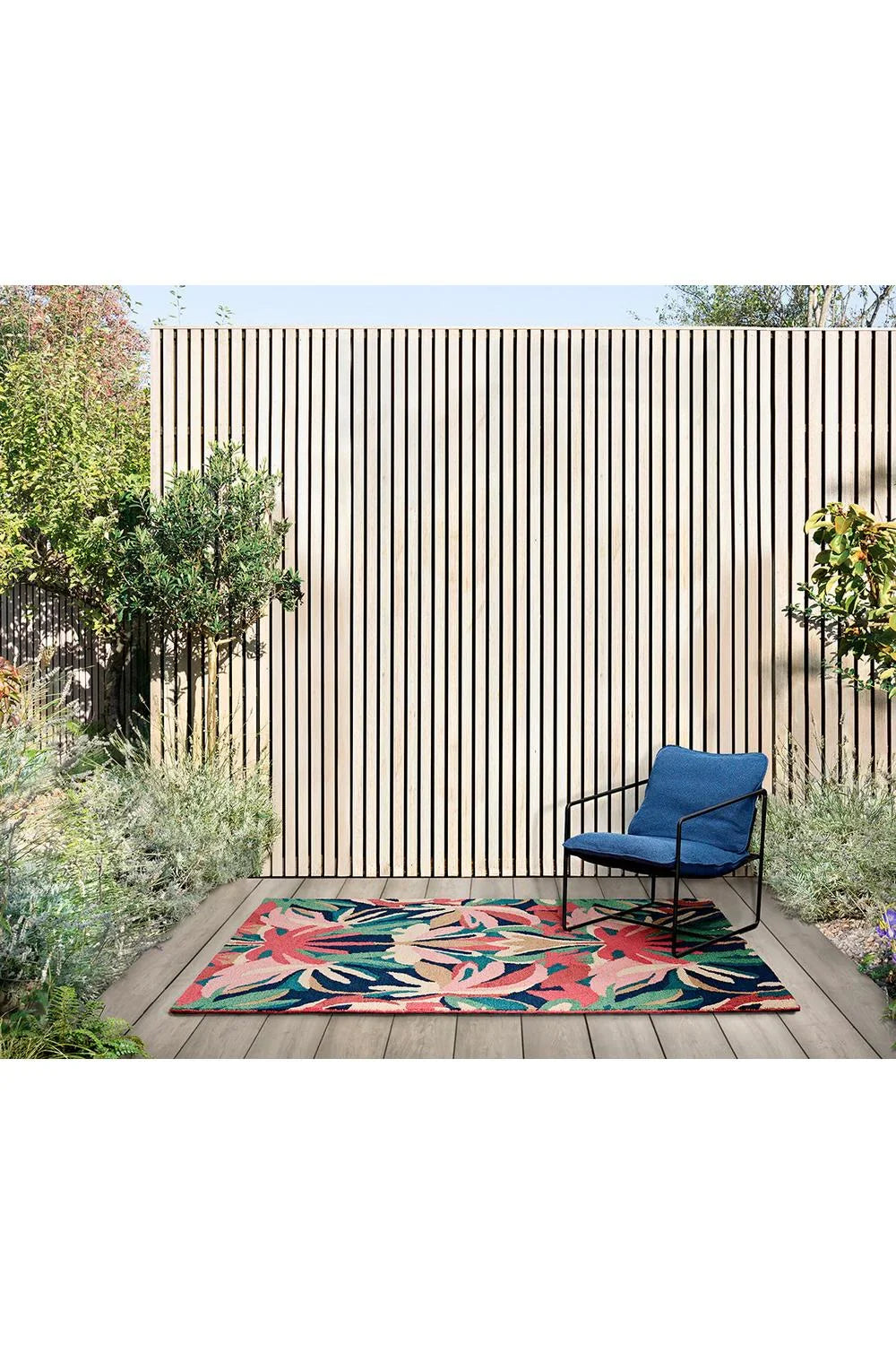 Harlequin Melora Pink Outdoor Rug featuring tropical leaf pattern in pink, teal, navy and cream on pink background, machine-woven polypropylene