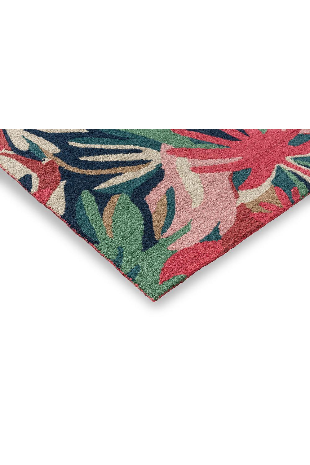 Harlequin Melora Pink Designer Outdoor Rug featuring tropical floral pattern in pink, green, navy on navy background; machine-made polypropylene