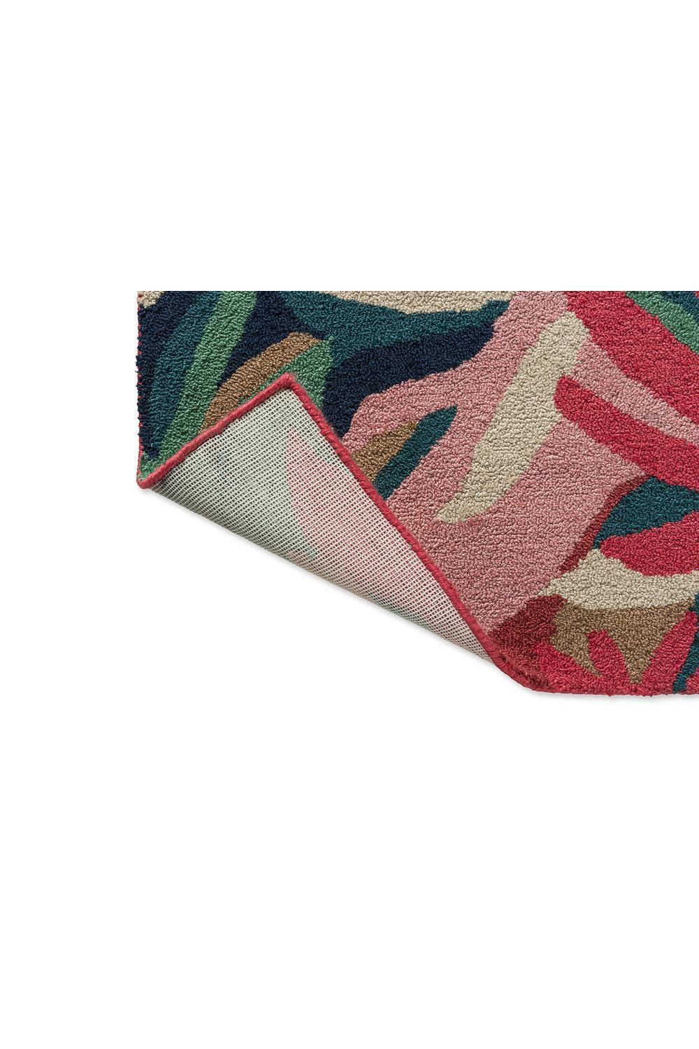 Harlequin Melora Pink Outdoor Rug featuring abstract tropical pattern in pink, fuchsia, emerald and navy on teal background, power-loomed polypropylene