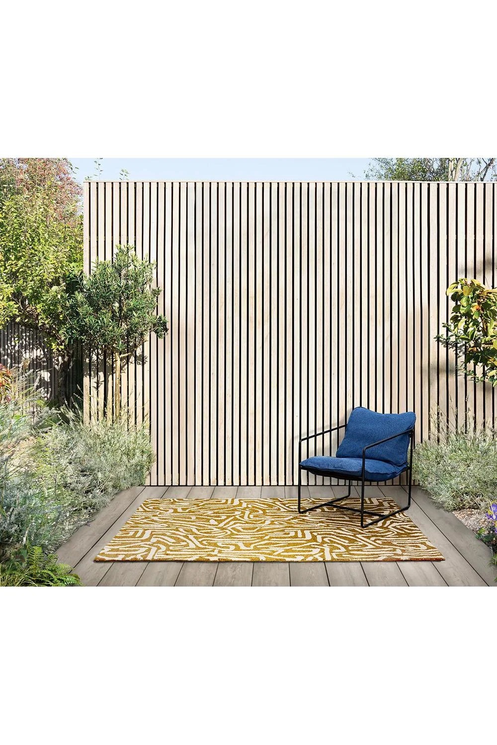 Harlequin Melodic Ochre - Gold outdoor rug featuring zebra stripe pattern in ochre and gold on beige background, machine-woven polypropylene
