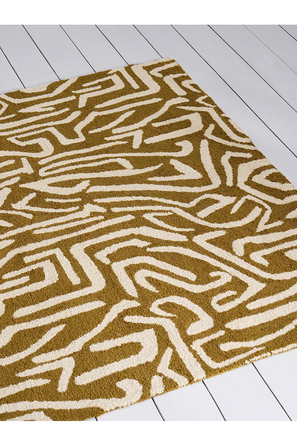 Harlequin Melodic Outdoor Rug featuring geometric maze in ochre and cream on pale background, power-loomed polypropylene
