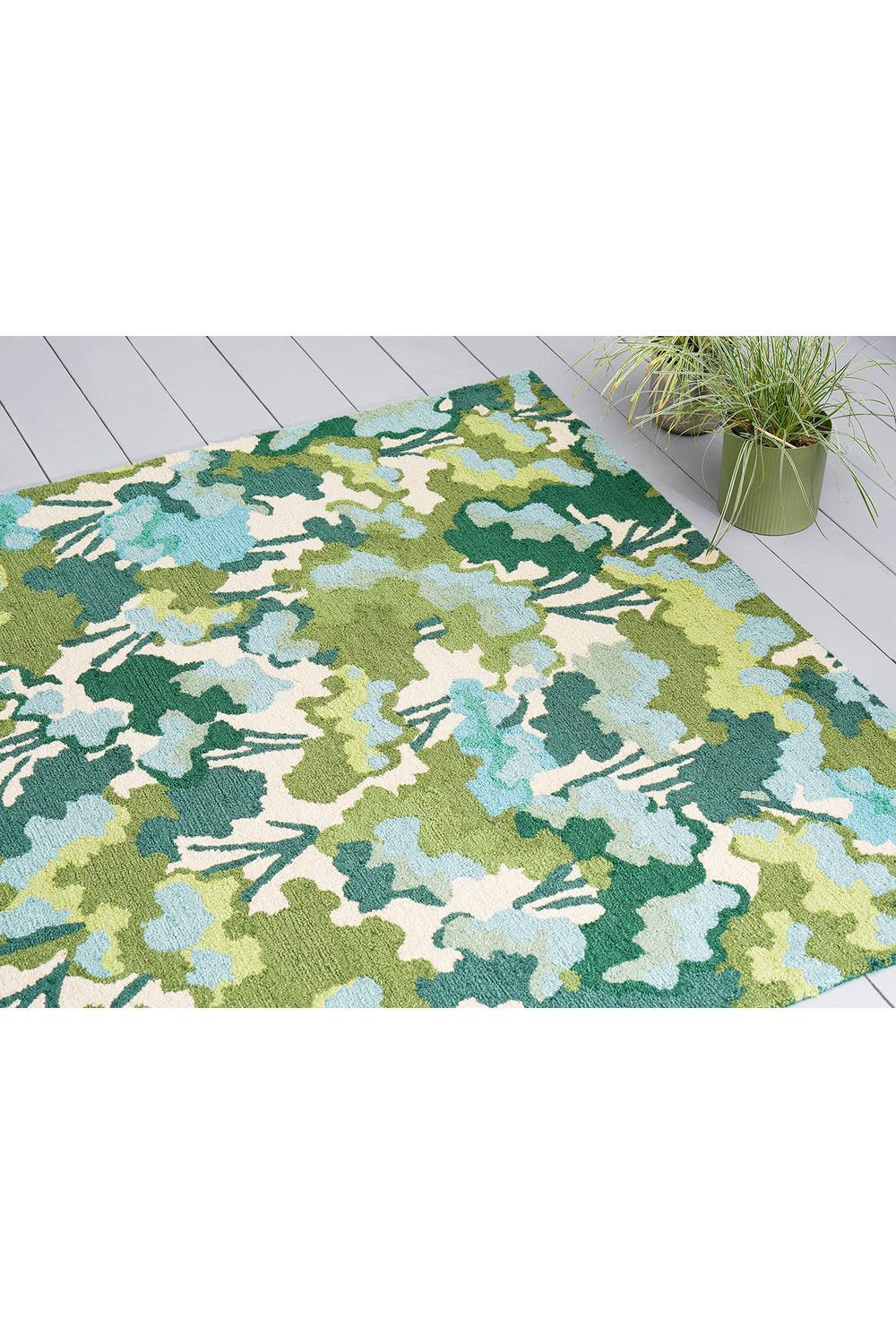 Harlequin Tree Tops Green Outdoor Rug featuring leafy abstract pattern in lime, sage, teal and cream on light background, machine-woven polypropylene